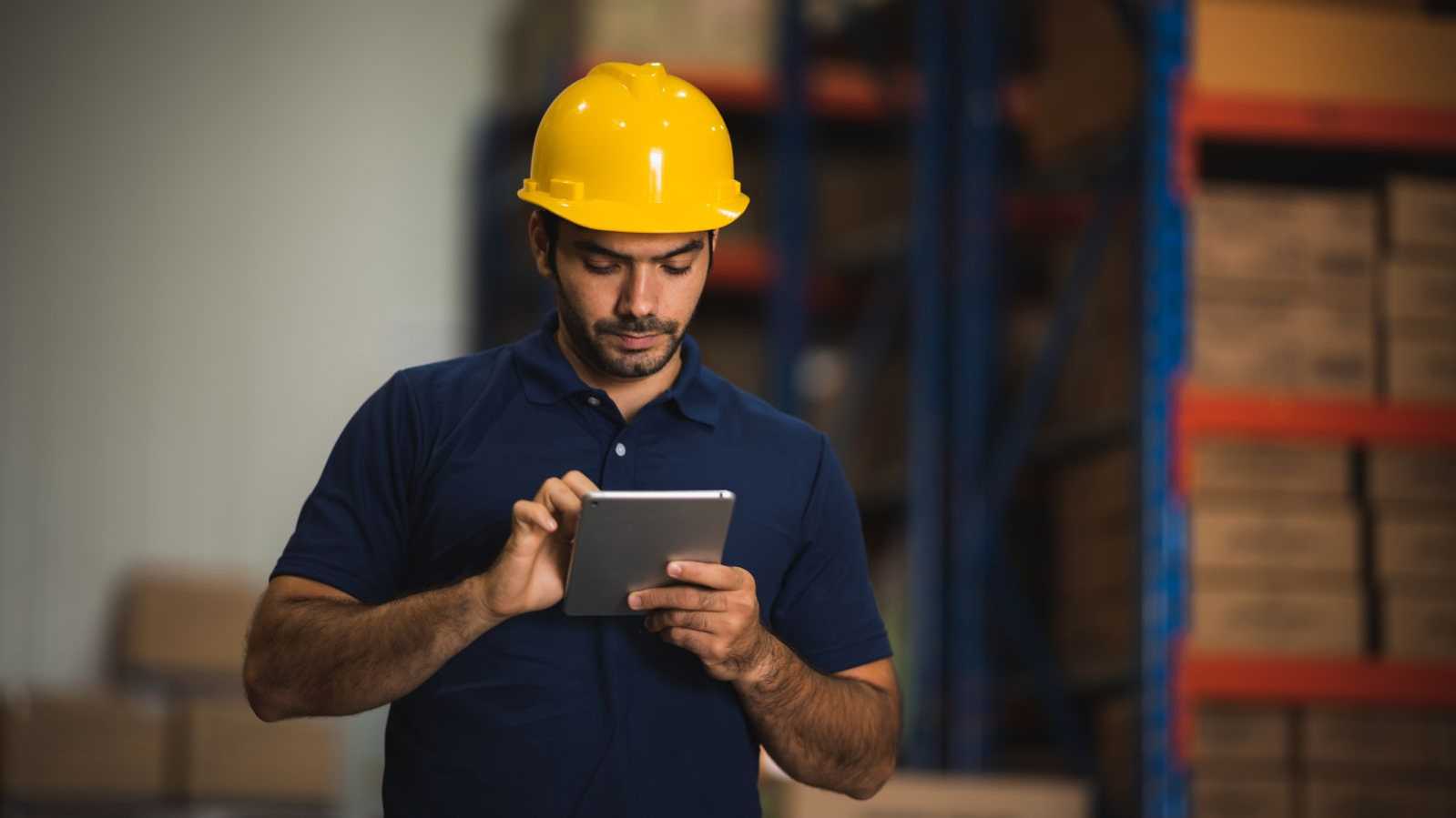 construction team member looking at tablet construction team member looking at tablet