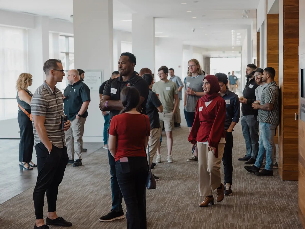 A diverse group of people socializing in a bright, spacious room
