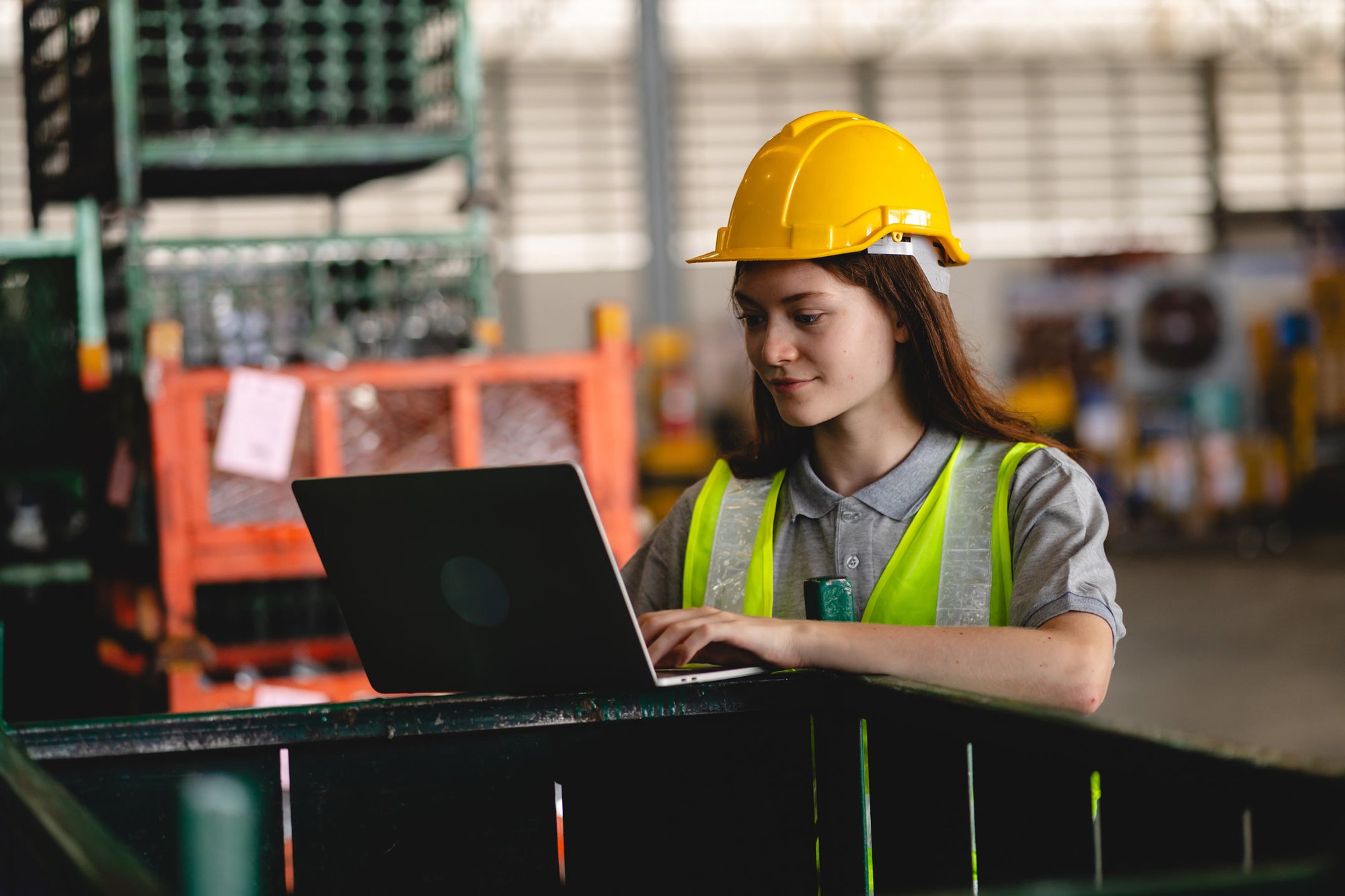 facility manager working on laptop in a warehouse
