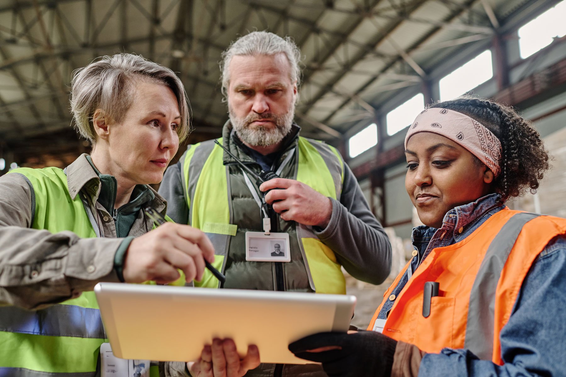 Discussing invoices on a tablet with workers