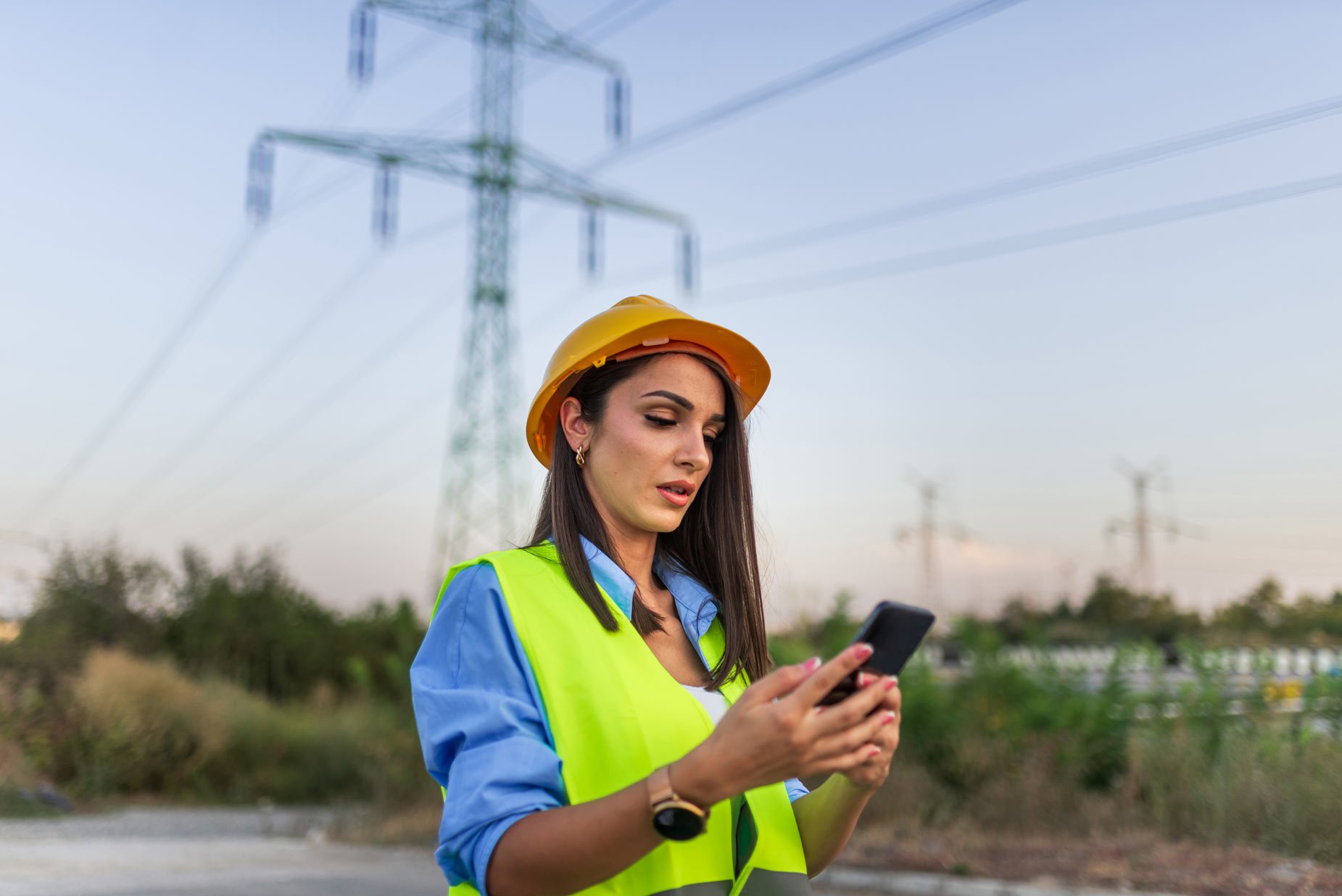 project manager looking at phone outside