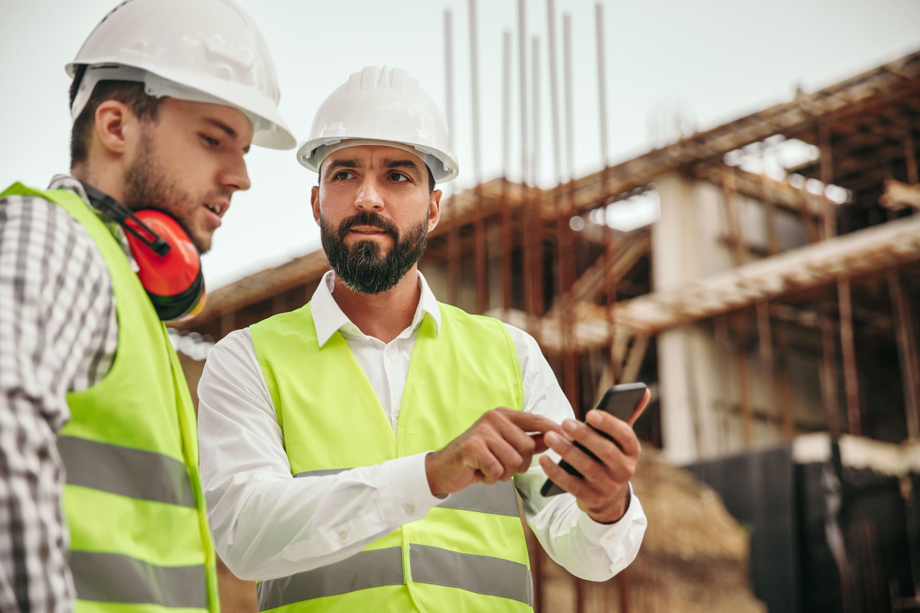 Technicians with smart phones at construction site