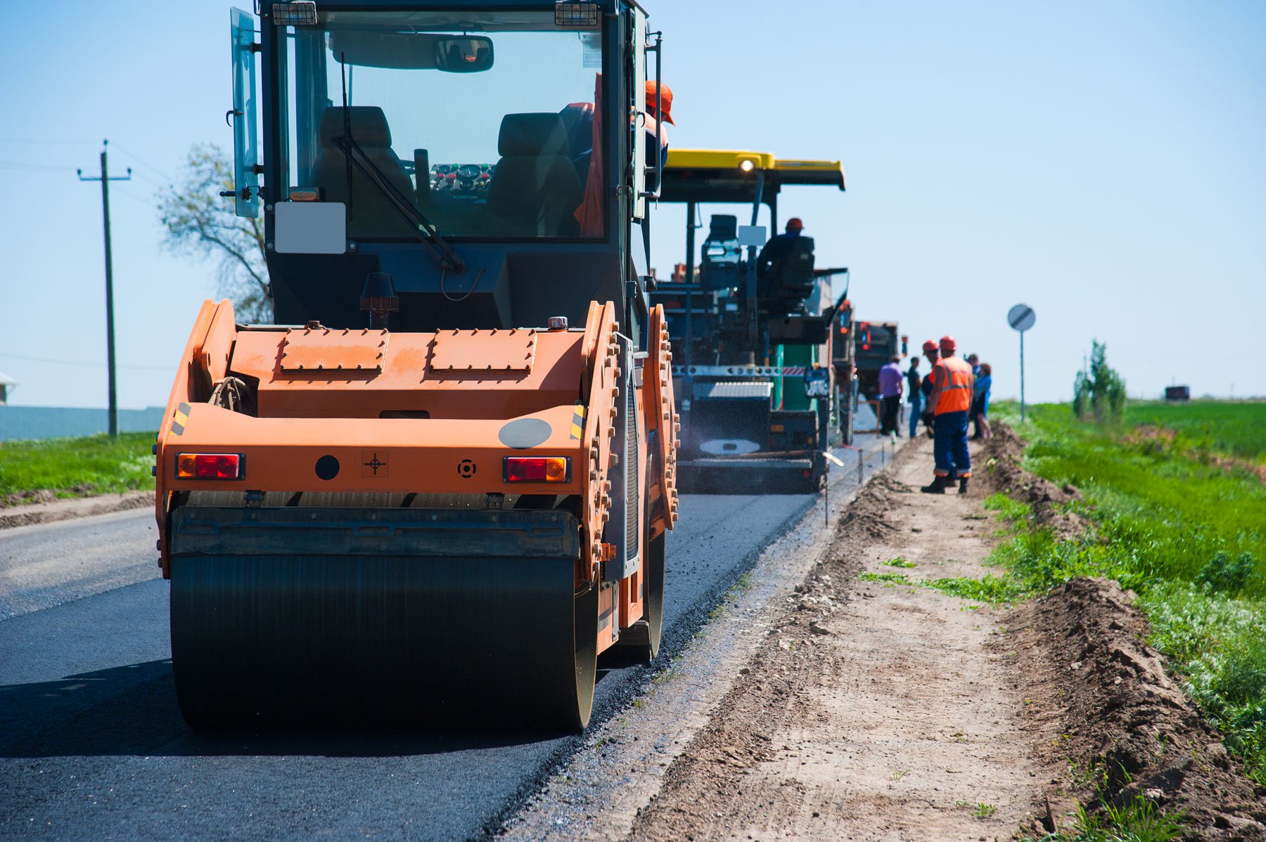 Heavy machinery, laying down asphalt on road