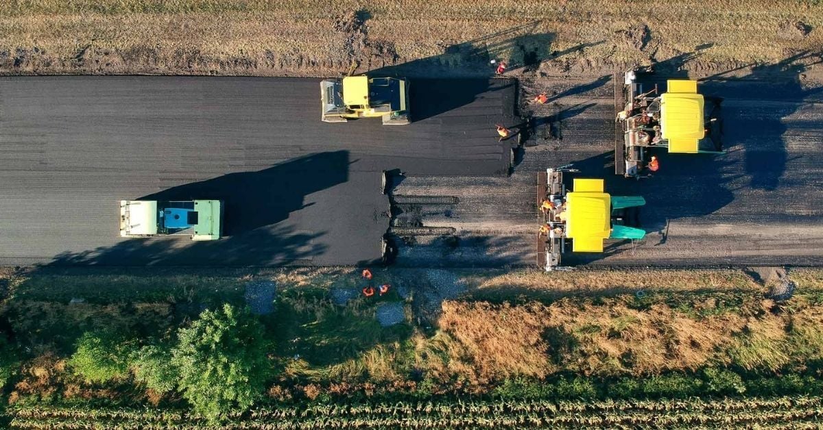 Aerial view of new asphalt road under construction