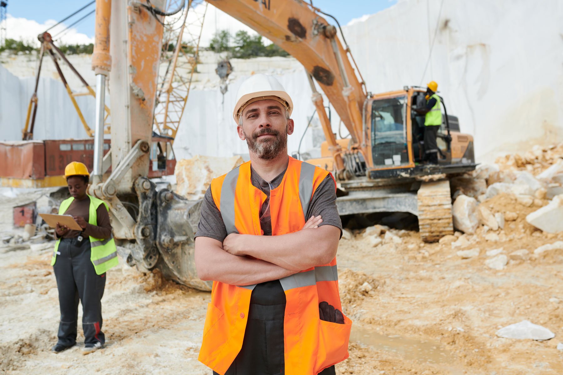 Construction worker while wearing a hardhat on site