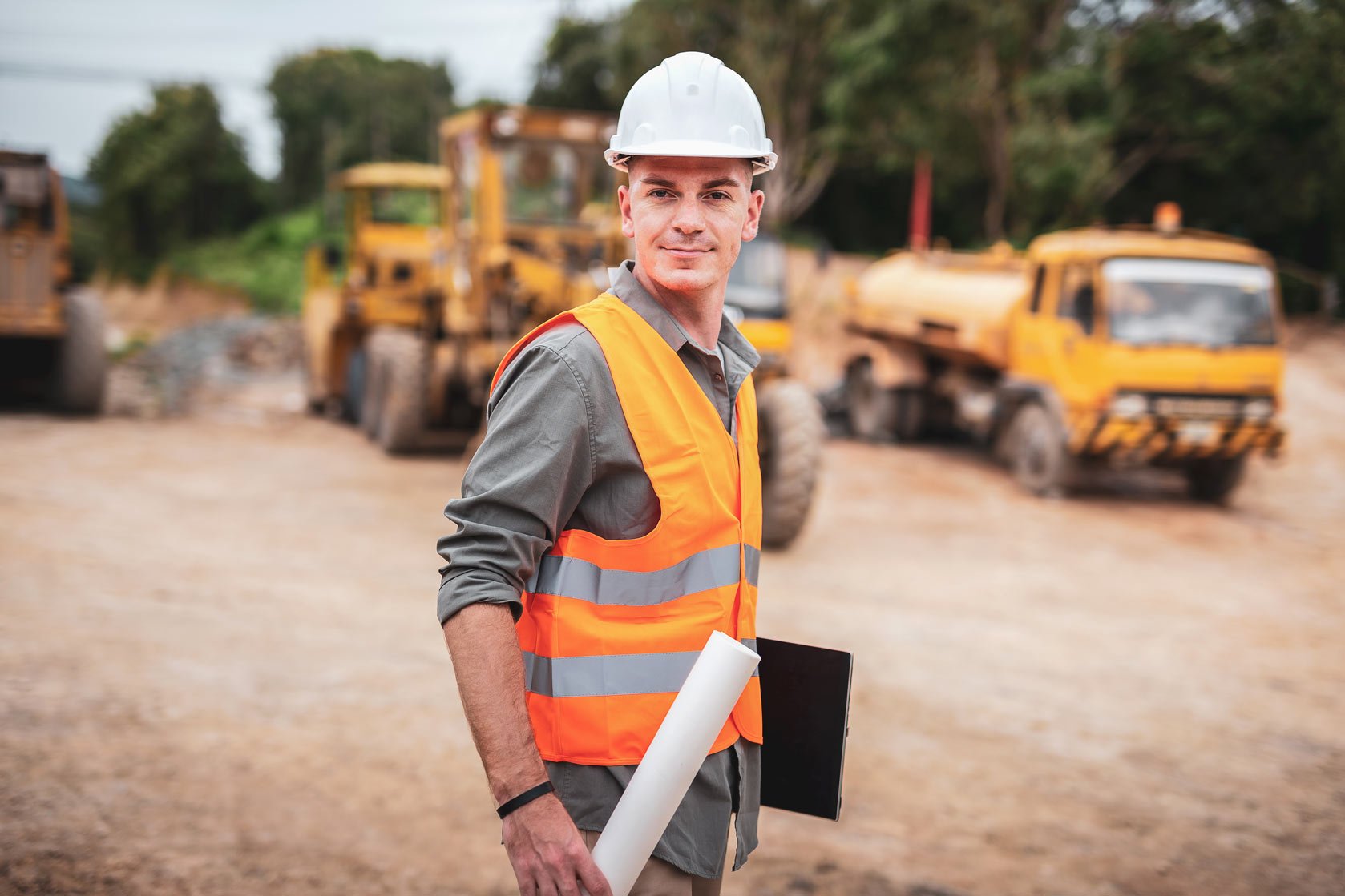 road construction worker using a saw to cut the cement road