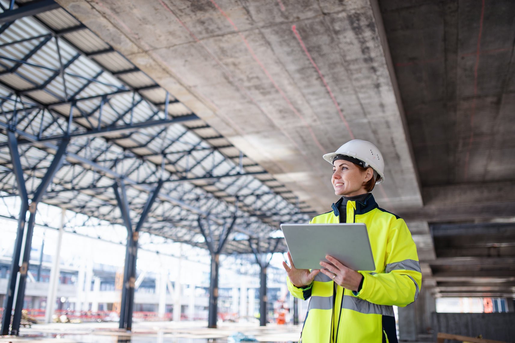 safety professional holding a tablet at a job site