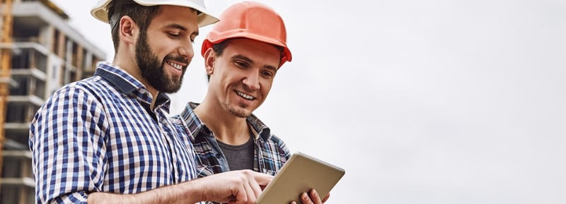 construction workers on a tablet