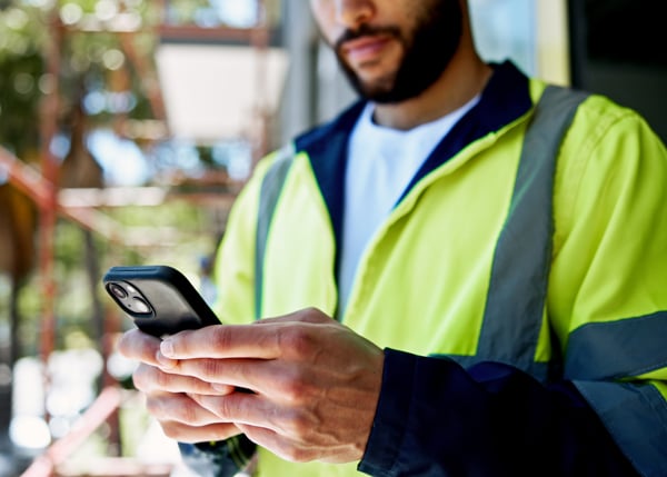 construction project manager looking at mobile device