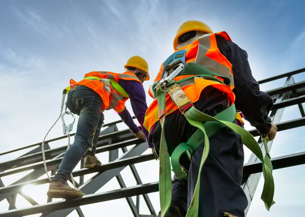 construction workers scaling framing