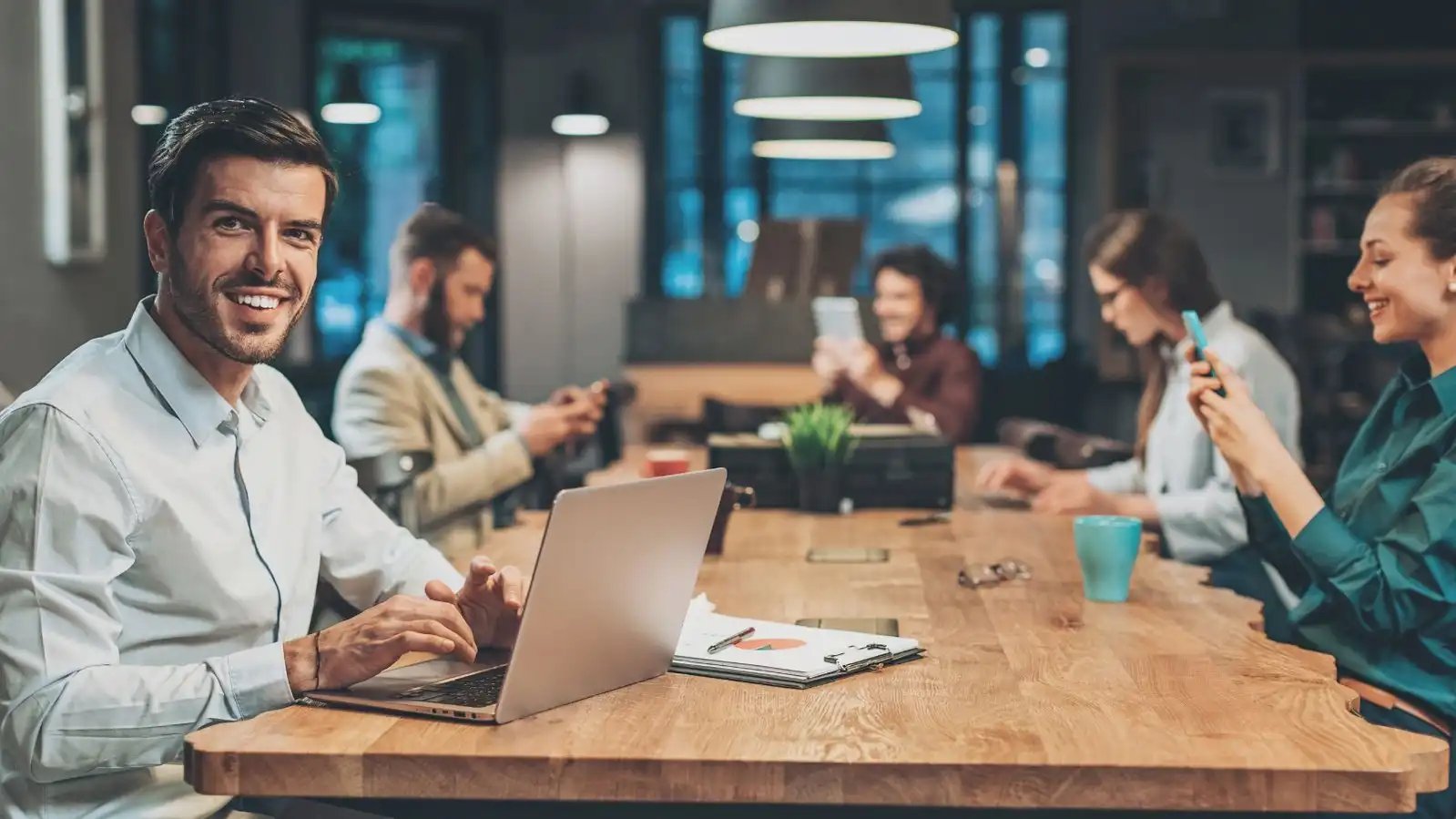 group of people sitting at a conference room table