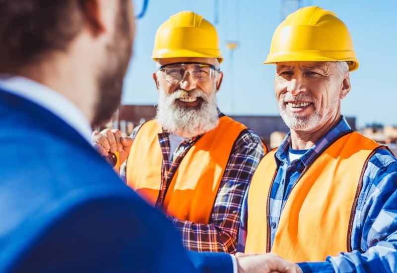 construction workers shaking hands