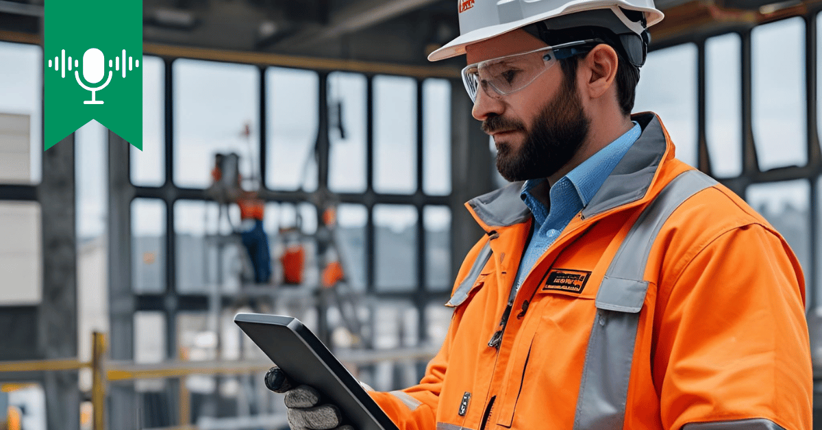 construction worker holding a tablet on site