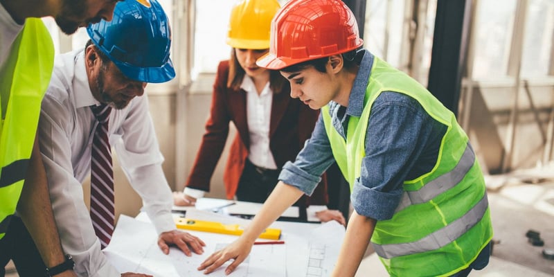 group of construction workers looking at a document