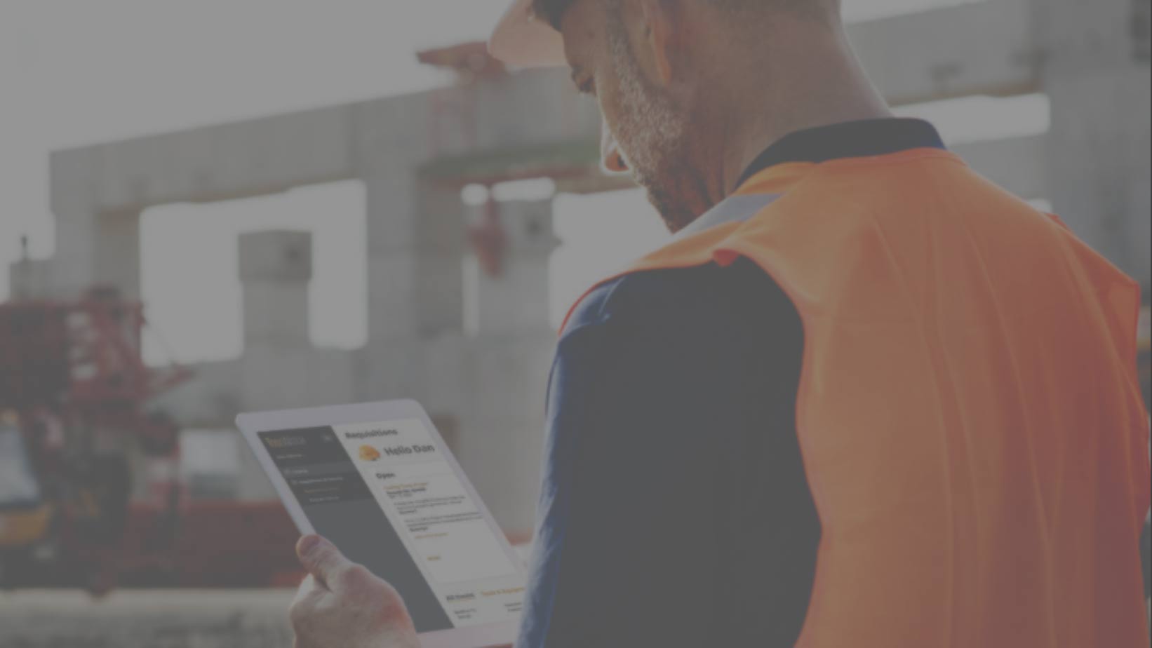 construction worker looking at ToolWatch app on ipad screen