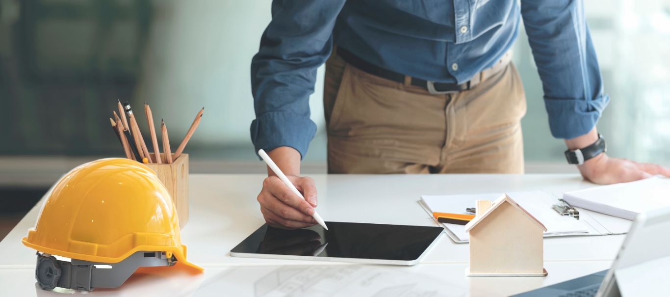 man writing on tablet